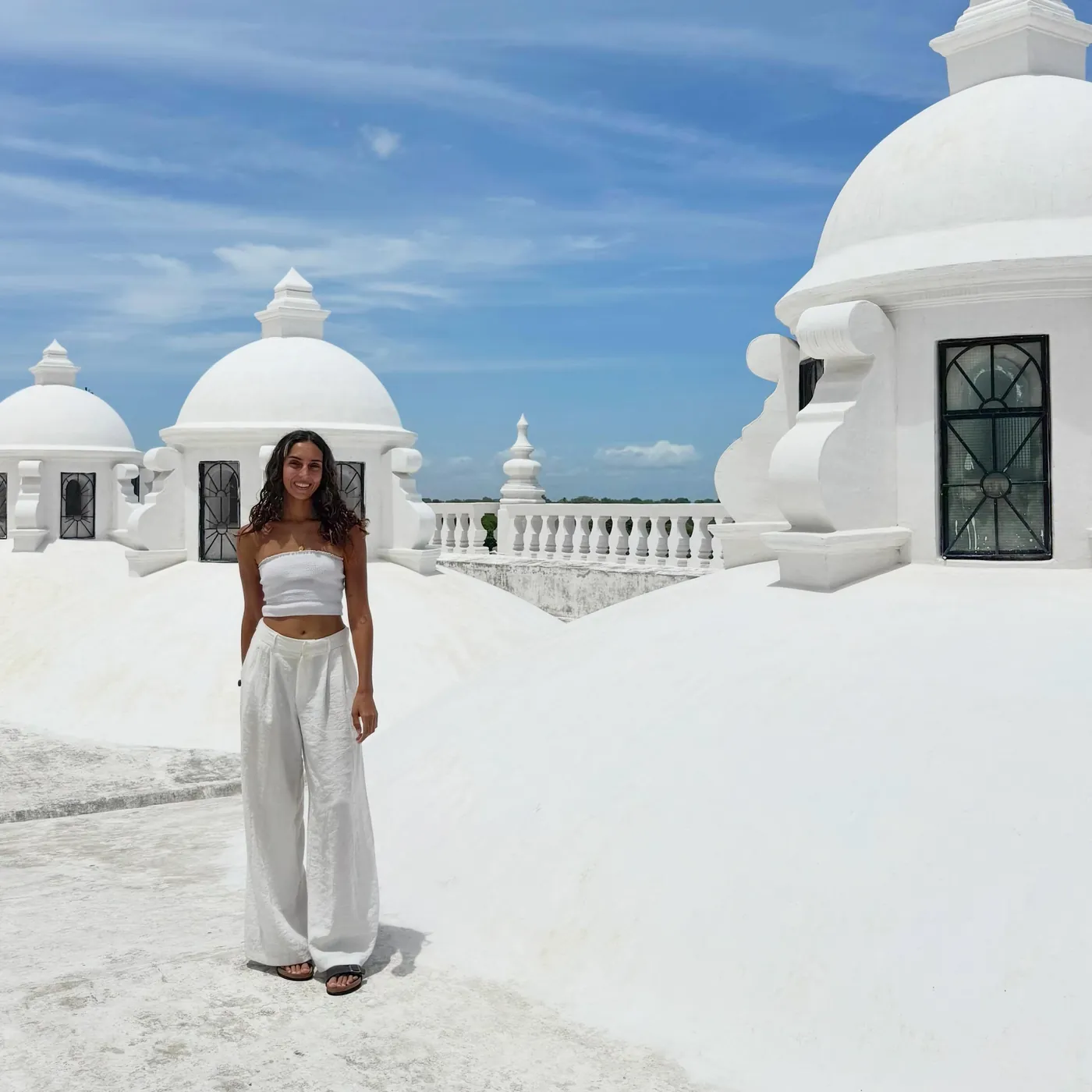 Natasha in white on the white domes of León cathedral roof