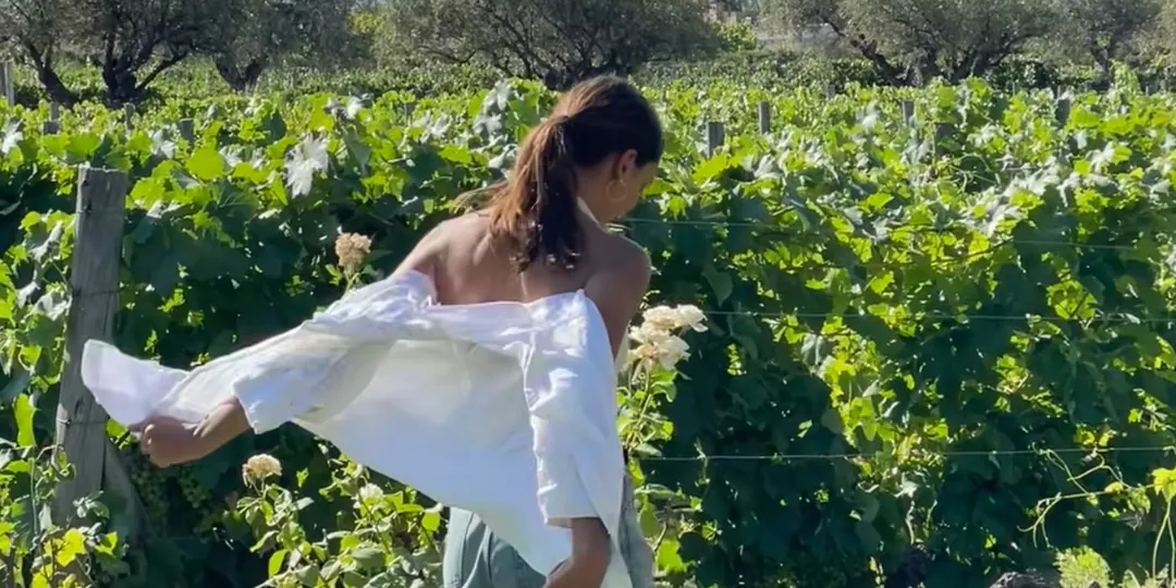 Natasha walking through a Mendoza vineyard